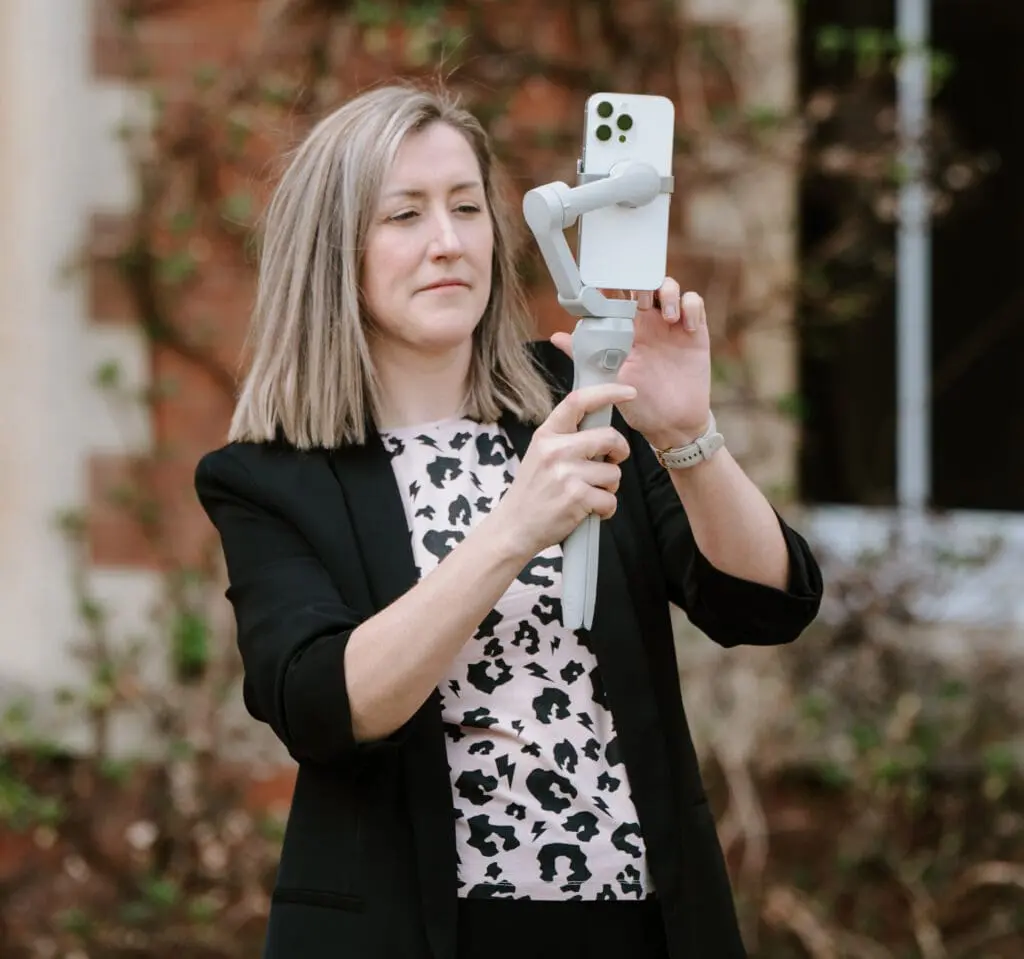 Wedding content creator from The Joy Is Reel filming on a phone gimbal