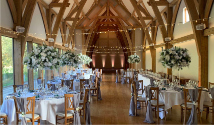 oak-beamed barn wedding reception with string lights and floral centrepieces, Worcestershire, wedding content creator coverage